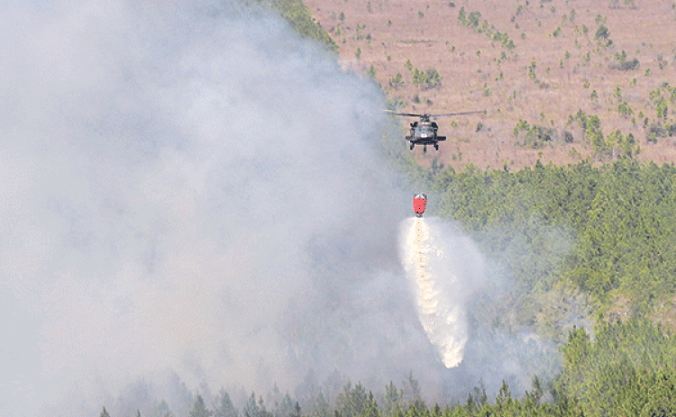 Louisiana National Guard aviators conduct water dropping missions to aid the Louisiana Department of Agriculture and Forestry, Louisiana State Fire Marshal office and local officials in combating the wildfires in Beauregard Parish near Deridder, Louisiana, Aug. 23, 2023.  (U.S. Army National Guard photo by Sgt. 1st Class Scott D. Longstreet)