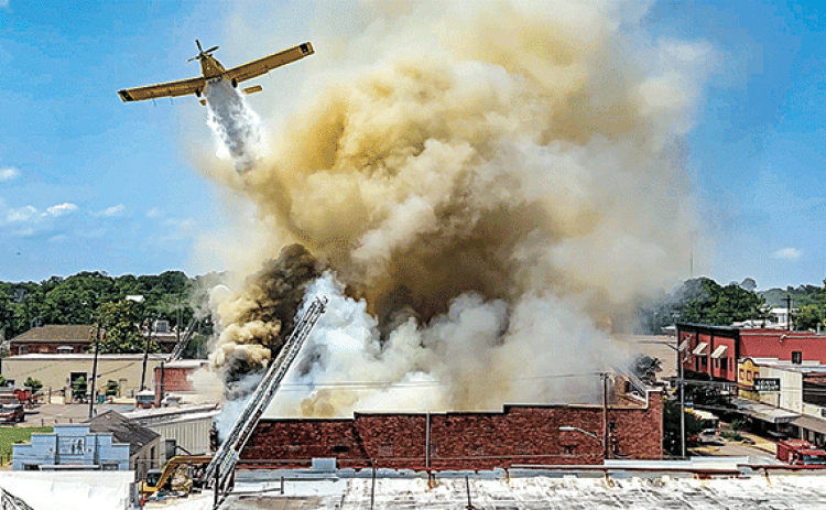 A crop duster flown by Robert Lejeune of Basile drops water on Nick’s on 2nd at about 1:30 p.m. Saturday, May 25. Eunice firefighters were dispatched to the fire at 11:53 a.m. Saturday. According to Fire Chief Chaise Brown on Tuesday a cause for the fire had not been established. There were no injuries reported from the fire. Eunice photographer Dwight Jodon captured his stunning image using a video mode on his camera then pulling the still image from it.