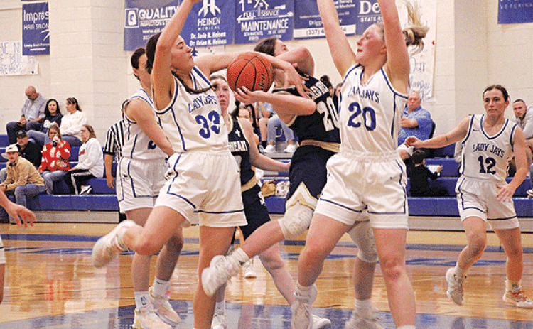 St. Ed’s Jillian Devillier and Ava Smith defend Sacred Heart’s Alyssa Brignac during a game of the Brad and Kendall Fontenot Memorial Shootout held at St. Ed’s last week. (Photos by Rhett Manual)