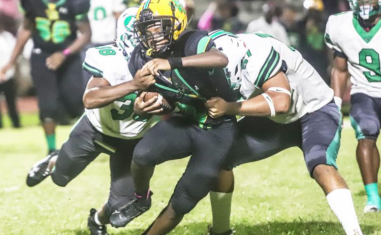 Eunice defense surrounds Washington Marion ball carrier