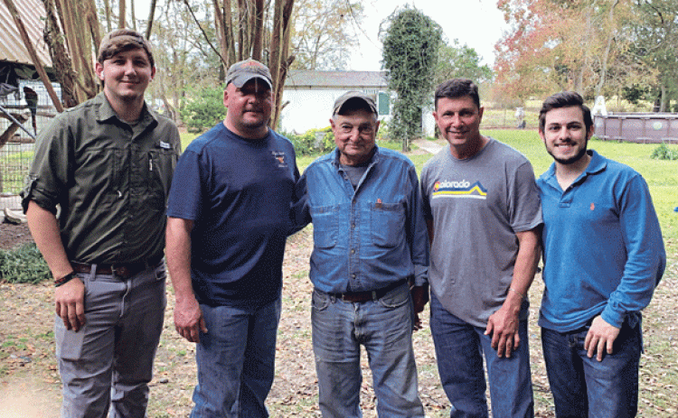 Opelousas farmer Floyd Dupre, center, stands with his son and partner Mike Dupre, second to left, and Joey Dupre, far right, his grandson at LSU. Also pictured are Joey’s father, Joseph Floyd Dupre, second from right, and another of Floyd’s grandsons, Dustin LaFleur, far left.(Photo courtesy of the Dupres)