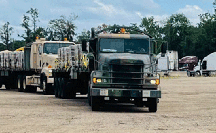 The Louisiana National Guard lines up trucks and trailers ready to deliver food and water to affected citizens following Hurricane Ida at the Regional Staging Area in Tangipahoa Parish, Louisiana, Aug. 28. 2021. In addition to 195 high-water vehicles and 73 rescue boats prepped and staged across south Louisiana, the LANG has 34 helicopters ready to support search and rescue, evacuation and recon missions as needed. (U.S. Army National Guard courtesy photo)
