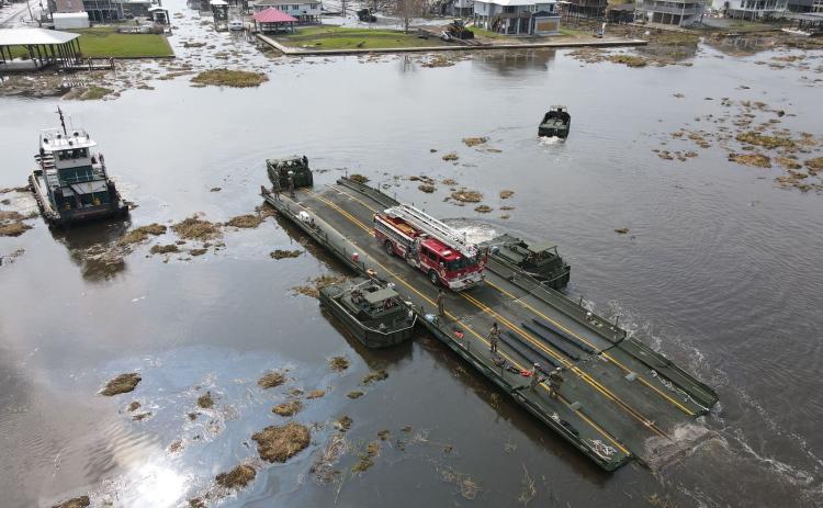 Louisiana National Guardsmen with the 2225th Multi-Role Bridge Company ferry emergency responders and equipment from Lafitte to Barataria to assist locals with recovery efforts, Jean Lafitte, La., Sept. 4, 2021. The only bridge to Barataria was damaged during Hurricane Ida and was rendered inoperable. (U.S. Army National Guard photo by 1st Lt. Steven McCoppin)