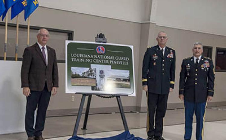 Louisiana Governor John Bel Edwards, Louisiana National Guard Adjutant General Maj. Gen. Keith Waddell and Louisiana National Guard Senior Enlisted Leader Command Sgt. Maj. Clifford Ockman unveil the Louisiana National Guard Training Center Pineville signifying the installation’s redesignation from Camp Beauregard to LANG TCP during a redesignation ceremony at the Dabadie Gym in Pineville, Louisiana, Oct. 18. (U.S. Army National Guard photo by Staff Sgt. Noshoba Davis)