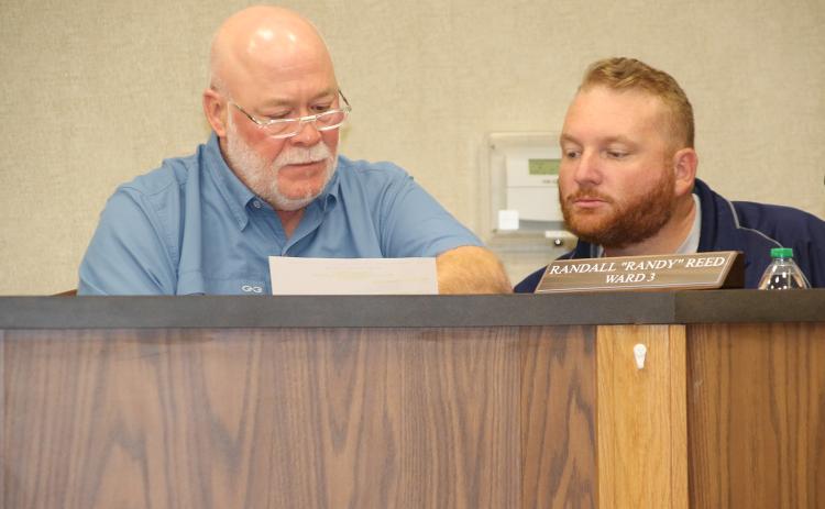 From left, Marion “Nootsie” Sattler, alderman at-large, and Randall “Randy” Reed, Ward 3 alderman, go over some paperwork at the April 11 meeting. (Photo by Harlan Kirgan)