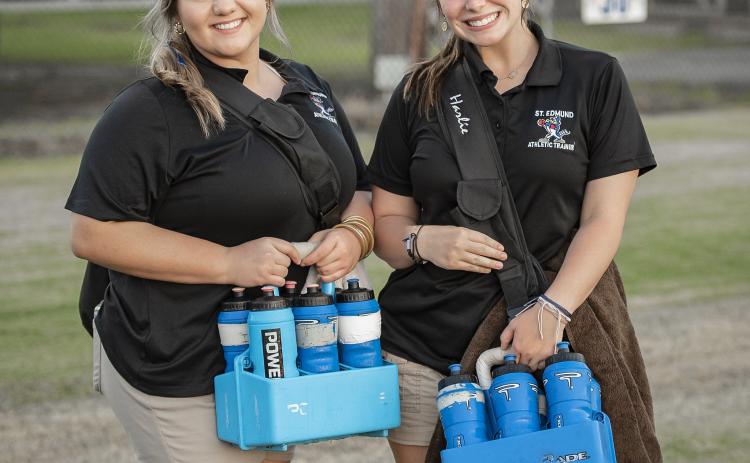 St. Edmund athletic trainers Ashlyn Marcantel and Harlie Guillory stop for a photo during the game against WCA Lafayette. (Photo by Dwight Jodon)