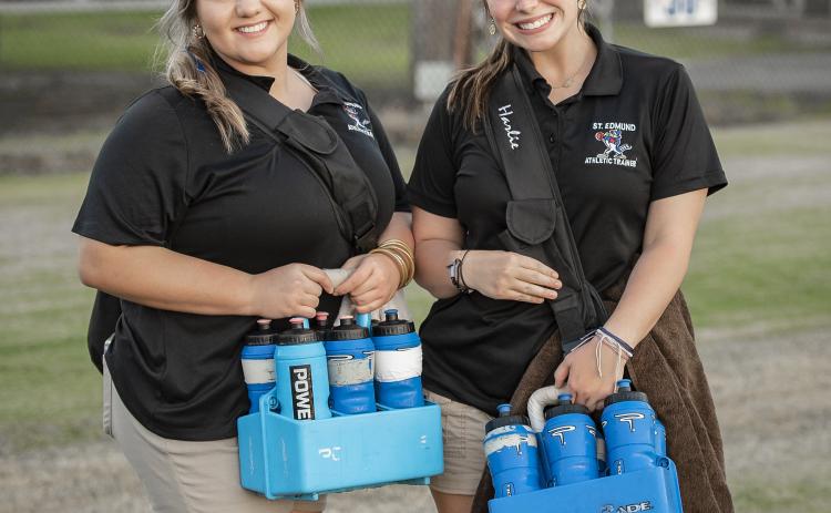 St. Edmund athletic trainers Ashlyn Marcantel and Harlie Guillory stop for a photo during the game against WCA Lafayette. (Photo by Dwight Jodon)