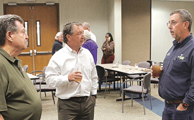St. Landry Parish President Jessie Bellard, right, discusses the proposal to build a juvenile detention facility to serve nine parishes with retired, from left, retired District Judge Ellis Daigle and Eunice attorney Donnie Richard after Wednesday’s Eunice Rotary Club meeting. (Photo by Harlan Kirgan)