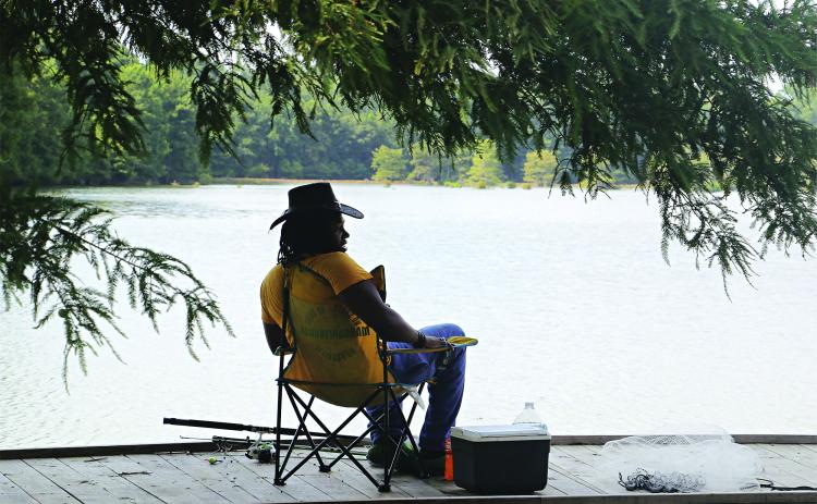 Temperatures were in the upper 80s on Thursday afternoon, but this shady spot on the edge of the Eunice City Lake felt comfortable. Tyler Fonville, of Eunice, was fishing there and said the fish were not biting. However, the turtles were biting and he had kept a few of them. (Photo by Harlan Kirgan)