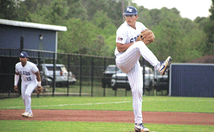 Clay Aguillard fires a pitch in St. Ed’s 8-3 win over Berchmans Academy in their opening game of the District 5-1A tournament on Thursday. Aguillard went four innings, didn’t give up an earned run and struck out four Saint hitters. (Photos by Rhett Manuel)