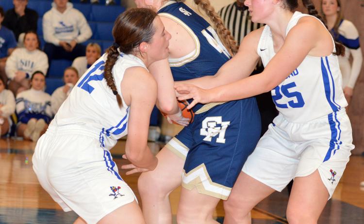 St Edmund’’s Caroline Lavergne and Millie Miller battle Sacred Heart’s Rose Ardoin for a jump ball.