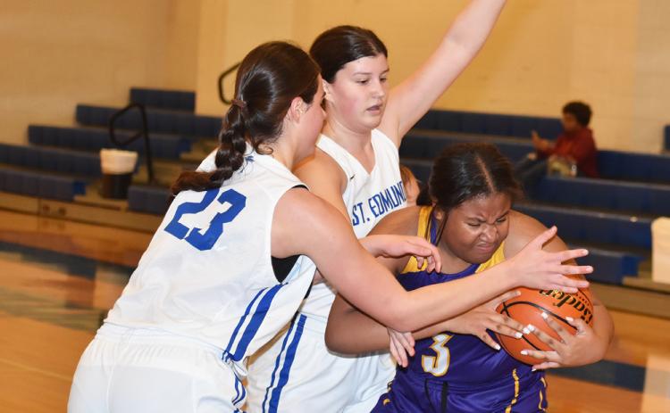 St. Edmund’s Aubrie LeJeune and Kennedy Dubroc surround Opelousas Catholic’s London Francis.