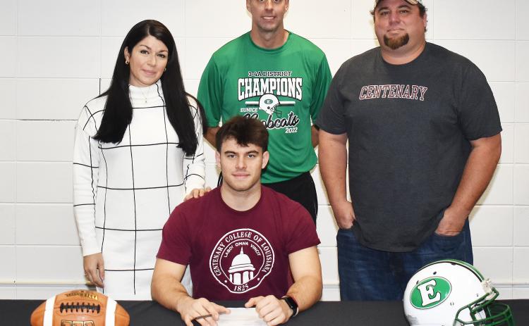 Eunice High’s Josh Brown, sitting, signed a national letter of intent to play football at Centenary College in Shreveport. Standing, from left, are his mother Kelly Arceneaux, Eunice head football coach Andre Vige and father Lance DeRouen.