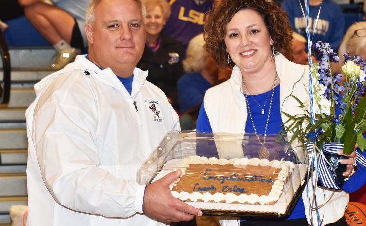 St. Edmund athletic director James Shiver presents head girls basketball coach Erica Zaunbrecher a cake, flowers and balloons after her 19th win – a season high record for the Lady Jays coach.