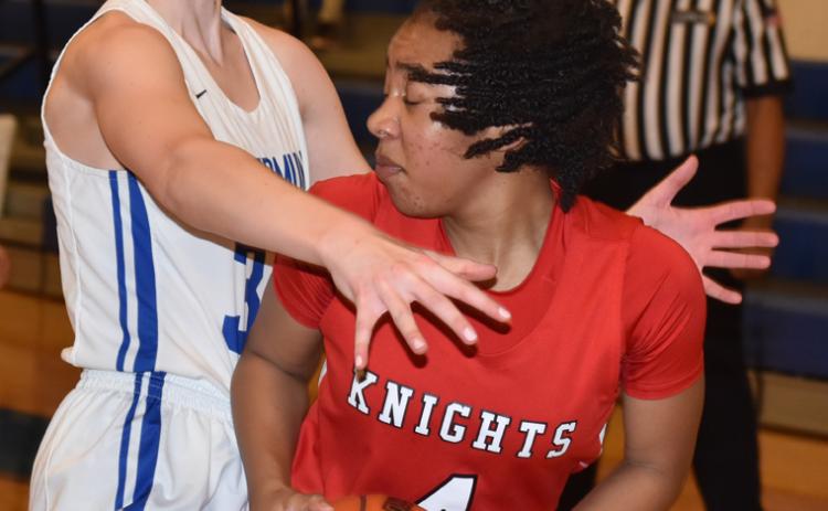 St. Edmund’s Madison Comeau defends Slaughter Community Charter’s Aubrie Jefferson.