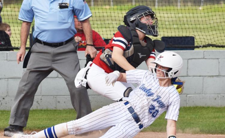 St. Edmund’s Caroline Lavergne slides past the tag of LCA catcher Kayden Hebert. (Photo by Tom Dodge)