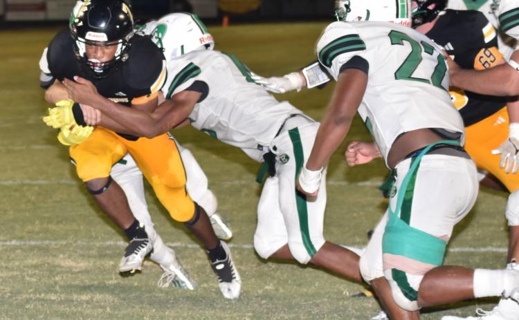 Eunice's Xavier Hebert and Lathan Kennedy stop Church Point's Tyrese Boast at the goal line.