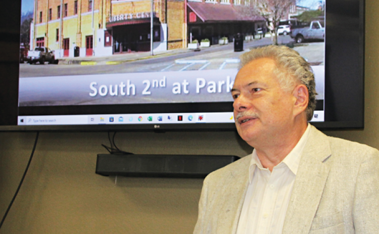 Paul Feavel shows a photo of how the Liberty Building appeared before renovation. (Photo by Myra Miller)