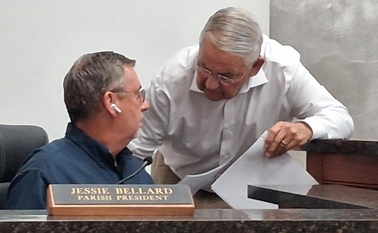 Harold Taylor speaks to parish president Jessie Bellard before the start of Tuesday’s special meeting.