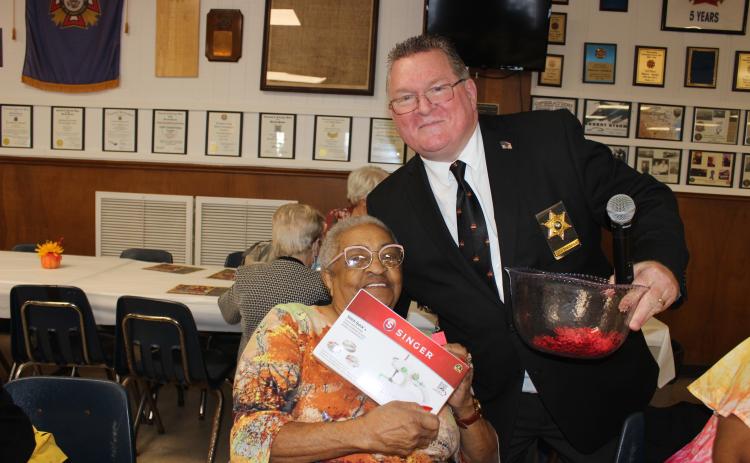 Dorita Augustine of Lafayette wins a door prize, with her is Chief Deputy Eddie Thibodeaux of St. Landry Parish Sheriff’s Office. (Photos by Myra Miller)