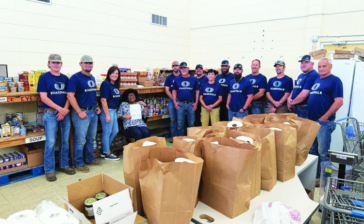Boardwalk calls this their Week of Caring. They provide four hours of volunteer time with trusted nonprofit partners, offering a variety of ways to give back to the community. This is an annual event that Boardwalk plans to do for the Eunice Food Bank. (Photo by Rebecca Chaisson)