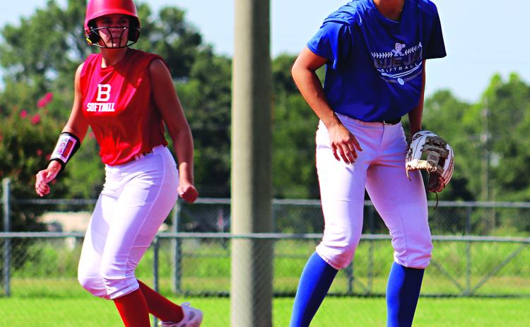 Ten teams from around Acadiana have been participating in Metro Ball being held at the Eunice Recreational Complex. At left, Basile’s Jensen Doucet attempts to leave first base as St Edmund’s Aubrie LeJeune plays first.