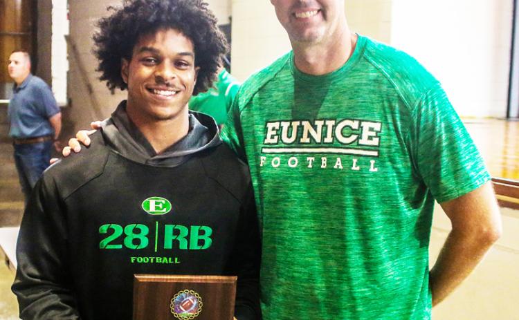 Eunice High head football coach Andre Vige presents the Jerry Hoffpauir Memorial Award to Deon Ardoin.