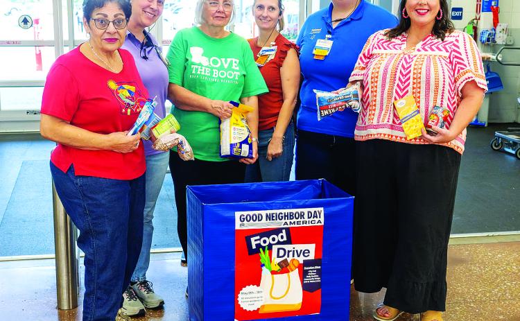 Posing in front of the Food Drive collection box at Walmart are, at left, Donna Baltakis, director of Keep Eunice Beautiful, sponsor of the drive; at third from left, KEB board member Fran Guillory; and, at right, Katie Richard, founder of Belly Buddies. They are pictured with Walmart associates Amanda Aymond, Rebecca Bordelon, and Courtney West. (Photo by David Simpson)