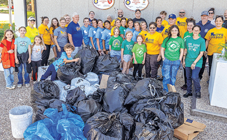 Volunteers assembled for a photo by City Hall after the cleanup on Saturday morning. (More photos on Page 2). (Photo by David Simpson)