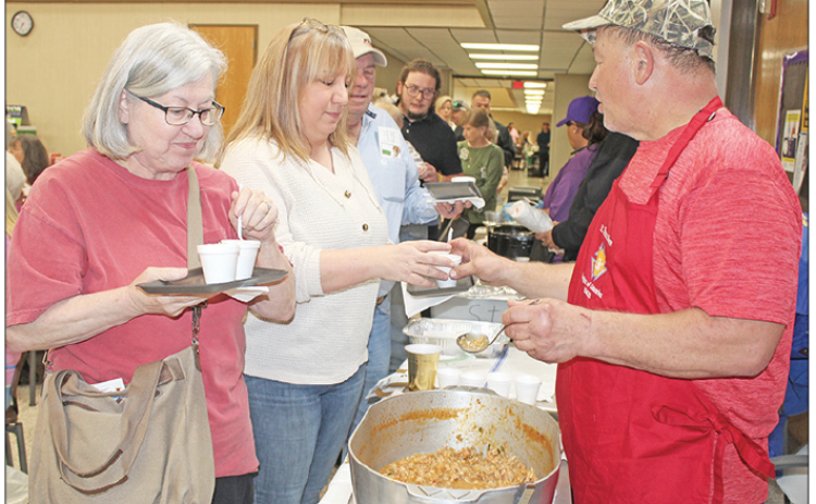The Taster’s Choice event was held Wednesday evening. Above, are Pat Bordelon, and Michelle Soileau receiving a sampling of crawfish etouffee from Malcolm Darbonne representing the St. Thomas More K.C.’s.
