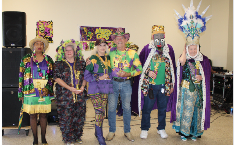 Judges were on hand at the annual COA Mardi Gras Dance held Monday to judge and name winners in different categories. From left are Peggy Marks as the Prettiest Costume and Stephanie Cormier won the Most Traditional Costume. The Best Female and Male Dancers award went to Shirley and Wallace Trahan; King crowned was Don Baggett; and winning Queen was Olita Bordelon. (Photo by Myra Miller)