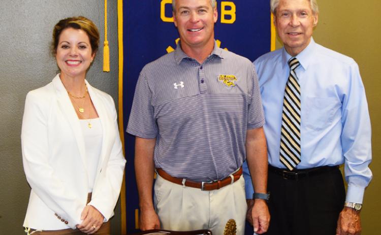 Eunice Rotary Club president Kitty Jo Deshotel joins LSUE head baseball coach Jeff Willis and Donald Mayeux