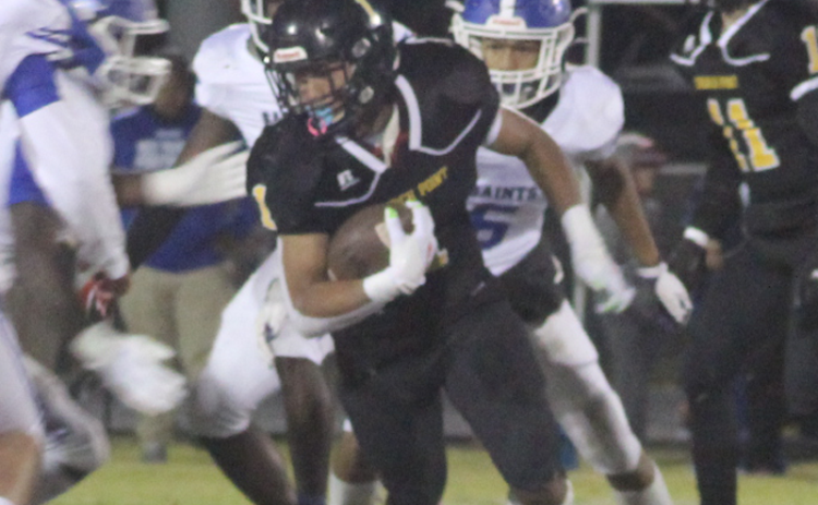 A Church Point runner faces a wall of West Feliciana players.