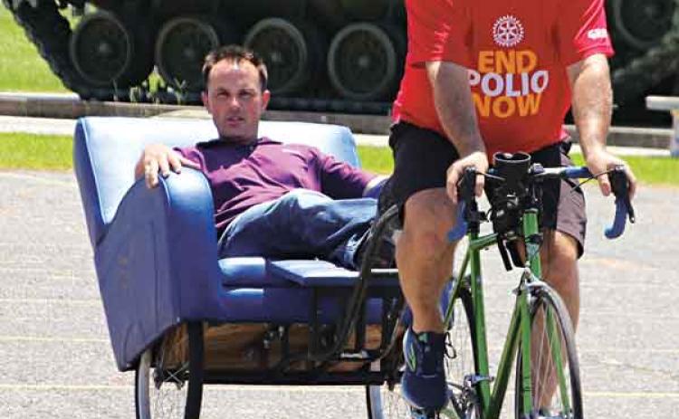 Ralph Zuke, a St. Louis, Missouri, Rotarian pedals Eunice Rotarian Coby Clavier at VFW Post 8971 on Thursday. Zuke was headed to the Rotary International Convention in Houston and raising money to eradicate polio. (Photo by Myra Miller)