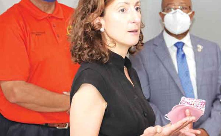 Dr. Tina Stefanski talks about the delta strain of the COVID-19 delta strain that is surging in Louisiana to record levels and filling hospitals during a news conference Monday at the Delta Grand Theatre in Opelousas. Behind her, from left, are Opelousas Mayor Julius Alsandor and St. Landry Parish Superintendent of Schools Patrick Jenkins. (Photo by Harlan Kirgan)