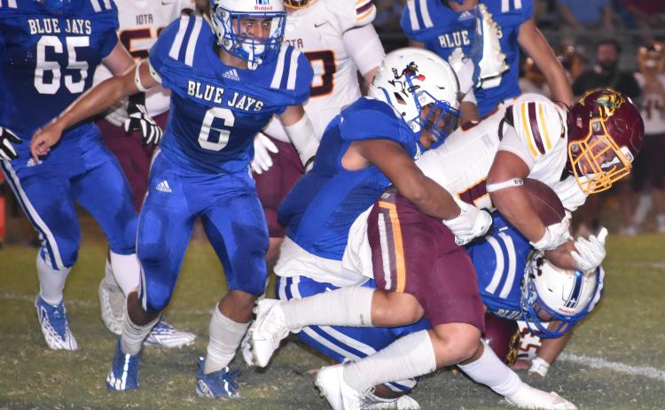 St. Edmund's Marcus Gradney tackles Iota running back Connor Fruge.
