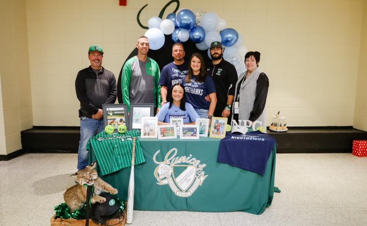 Eunice High third baseman Alexis Ortego,sitting, recently signed to play softball at National Park College in Hot Springs, Arkansas. Standing, from left, are assistant softball coach Ryan Vienne, EHS athletic director Andre Vige, father Mike Doucet, mother Lessie Doucet, head coach ball coach Trenon Trosclair and EHS principal Irma Trosclair. (Photo by Bailey Turner)
