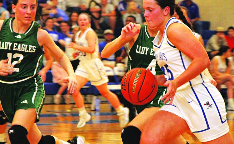 St. Edmund’s Millier Miller drives with the ball past Ouachita Christian Lady Eagles defenders. The Lady Jays lost 41-39 in a game that went down to the sire and ended their season. (Photo by Rhett Manuel)