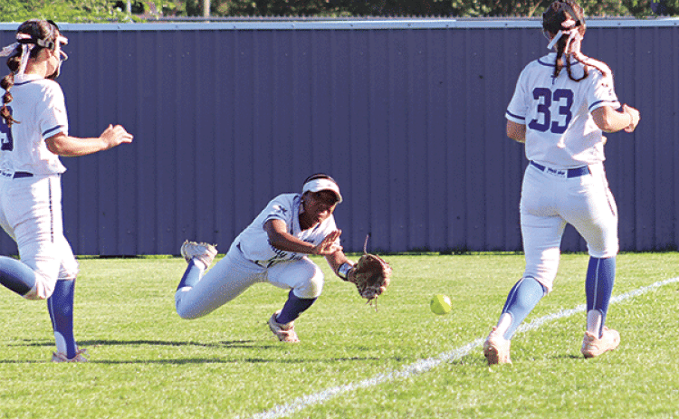 Malori Bellard, a St. Edmund right fielder, dives for a fly ball in the game with Northside Christian. (Photo by Amy Myers)
